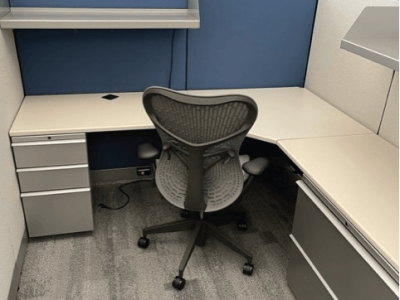 Blue and white cubicle with chair